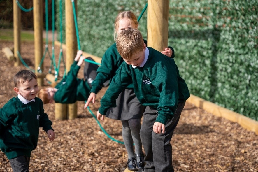 Pupils balancing on the rope trail in the school’s outdoor play area